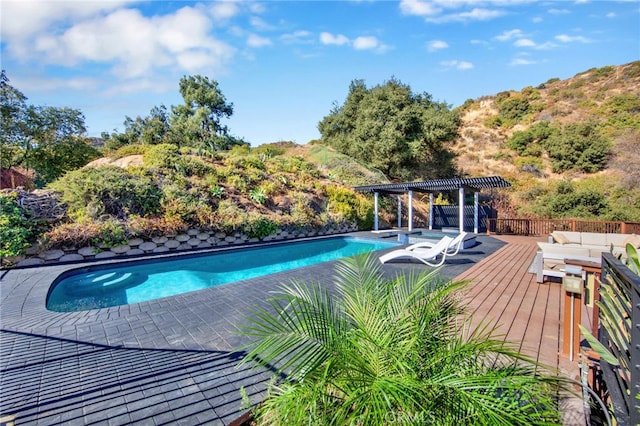 view of swimming pool featuring a pergola and a deck