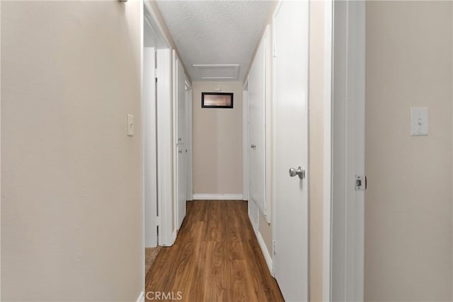 hall featuring a textured ceiling and light wood-type flooring