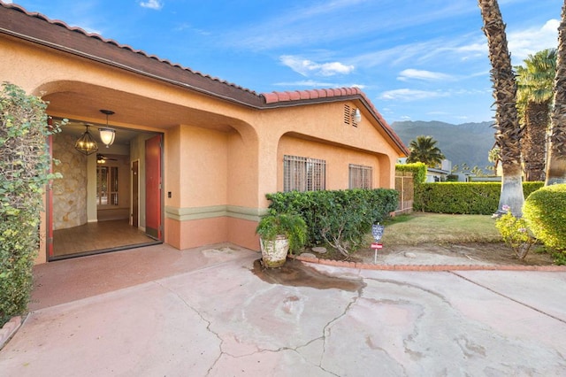 doorway to property featuring a mountain view and a patio area