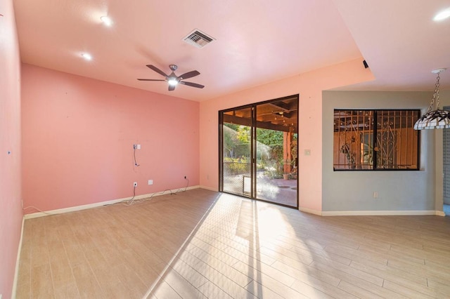 spare room featuring light hardwood / wood-style floors and ceiling fan