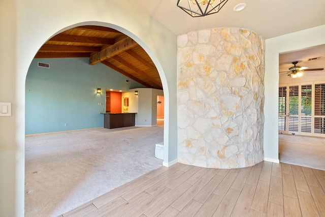 unfurnished living room with carpet flooring, lofted ceiling with beams, ceiling fan with notable chandelier, and wooden ceiling