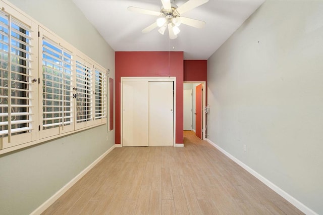 unfurnished bedroom with ceiling fan, a closet, and light hardwood / wood-style floors