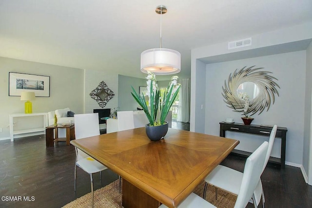 dining room with dark hardwood / wood-style flooring