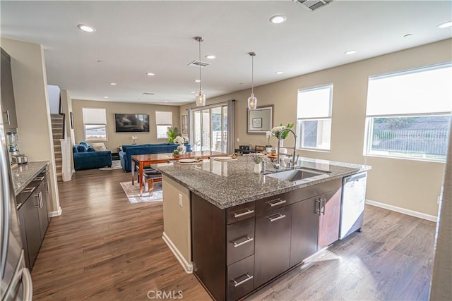 kitchen with dark brown cabinets, sink, a wealth of natural light, and dark wood-type flooring