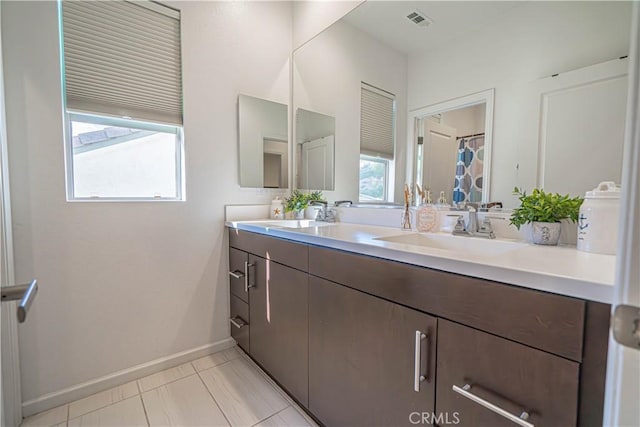 bathroom with tile patterned floors and vanity