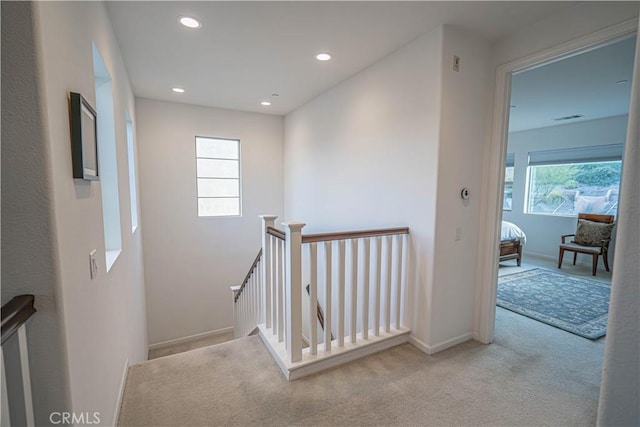 hallway featuring light carpet