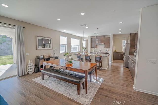 dining space with light hardwood / wood-style floors