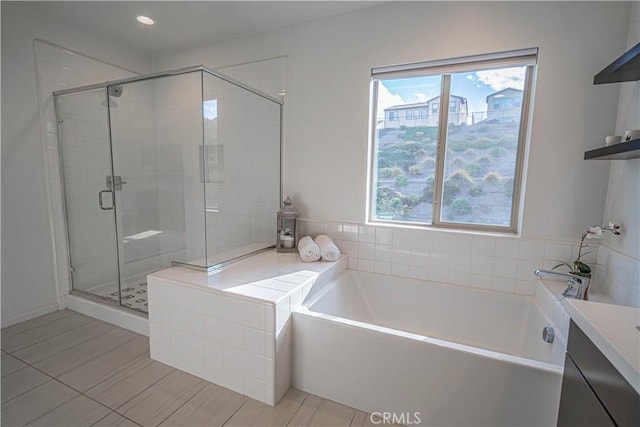 bathroom with tile patterned flooring, vanity, and independent shower and bath