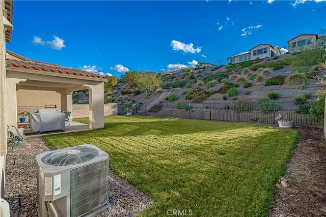 view of yard featuring central air condition unit and a patio