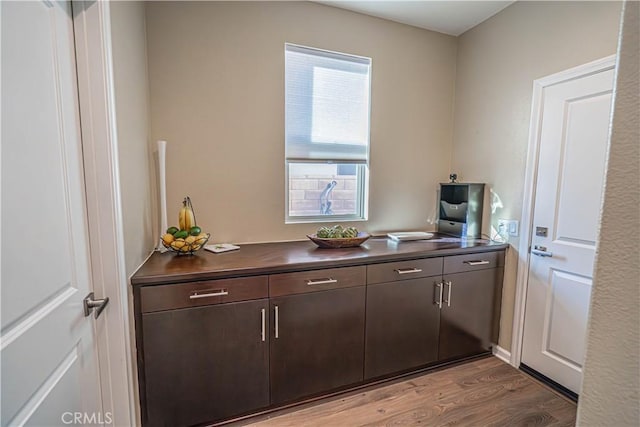 interior space with dark brown cabinets and light hardwood / wood-style floors