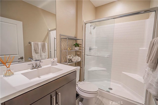 bathroom with vanity, toilet, and an enclosed shower