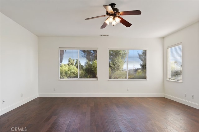 unfurnished room with a wealth of natural light and dark wood-type flooring