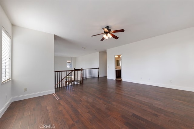 unfurnished room featuring ceiling fan and dark wood-type flooring