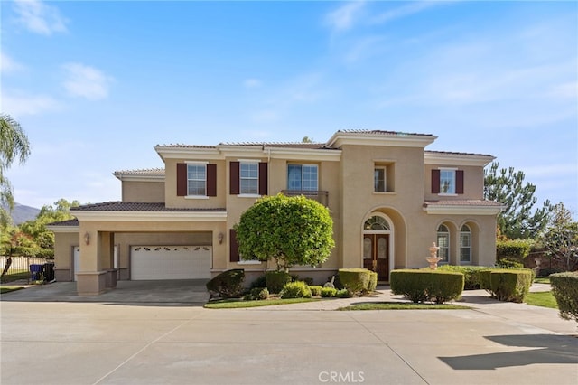 mediterranean / spanish home featuring a garage