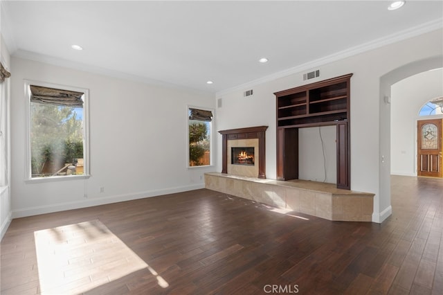 unfurnished living room with a fireplace, dark wood-type flooring, and ornamental molding