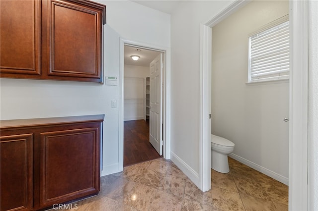 bathroom featuring hardwood / wood-style floors and toilet