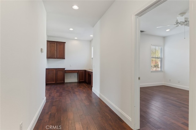 corridor with dark hardwood / wood-style flooring