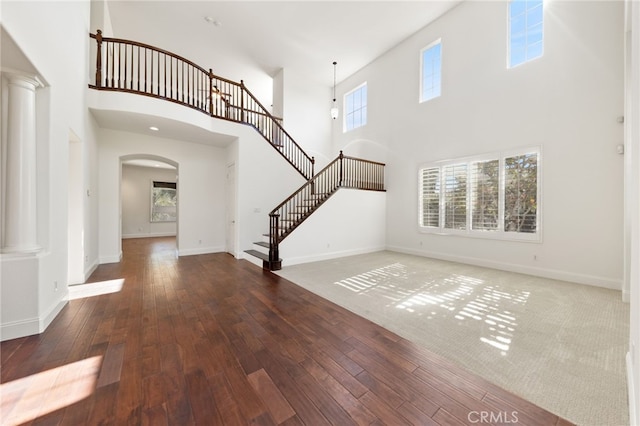 entryway featuring hardwood / wood-style floors and a high ceiling