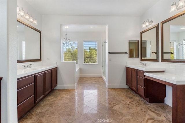 bathroom featuring vanity, independent shower and bath, and an inviting chandelier