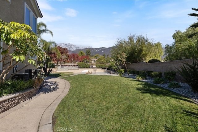 view of community featuring a mountain view and a lawn