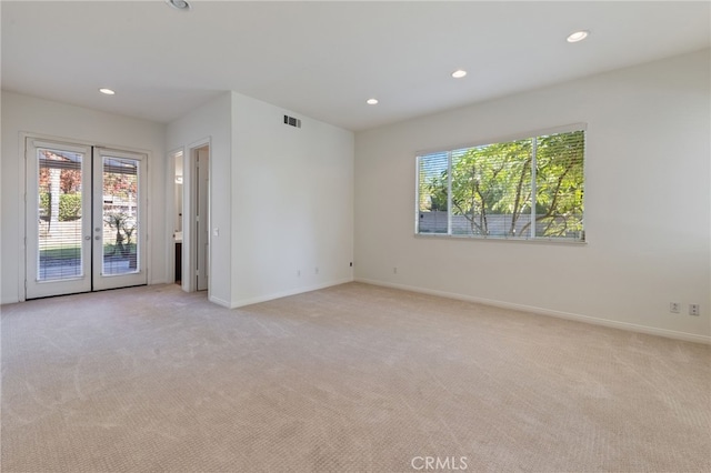 carpeted empty room with french doors