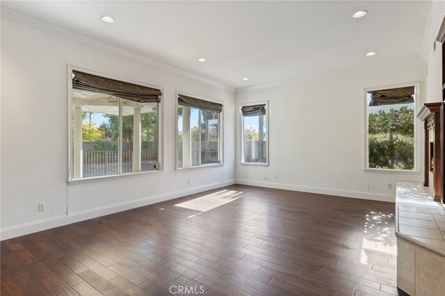 unfurnished living room featuring dark hardwood / wood-style flooring and crown molding