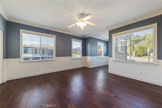 spare room featuring dark hardwood / wood-style floors, ceiling fan, and crown molding