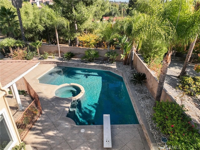 view of swimming pool with a patio area and an in ground hot tub