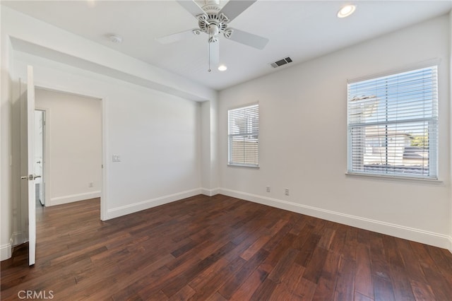 unfurnished room featuring ceiling fan and dark wood-type flooring