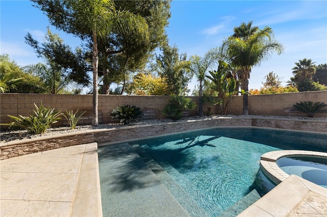 view of swimming pool featuring an in ground hot tub