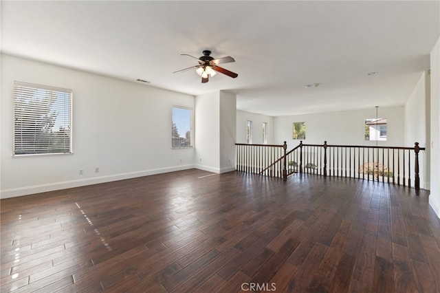 spare room with dark hardwood / wood-style floors and ceiling fan