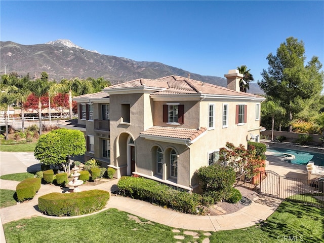 mediterranean / spanish home with a fenced in pool and a mountain view