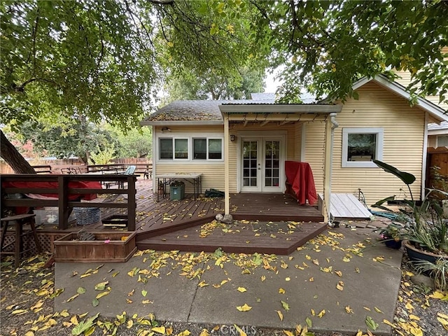 back of house with french doors and a wooden deck