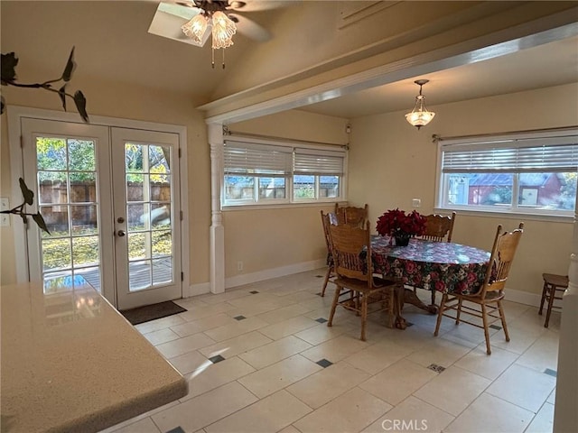 tiled dining room featuring ceiling fan and french doors