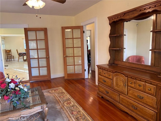 interior space featuring dark hardwood / wood-style floors, ceiling fan, and french doors