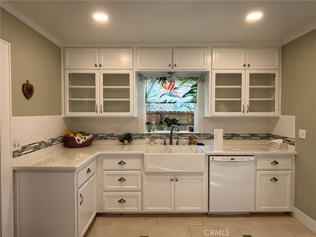 kitchen featuring dishwasher, light tile patterned flooring, white cabinetry, and sink