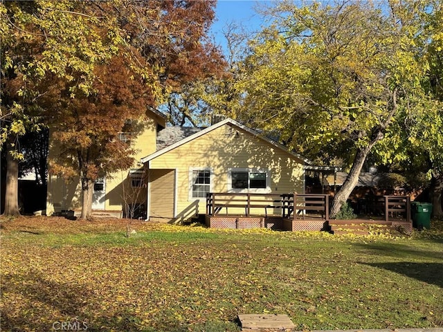 back of house with a lawn and a wooden deck