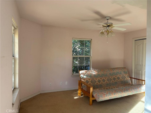 sitting room featuring ceiling fan and carpet floors