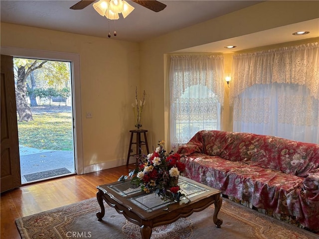 living room featuring hardwood / wood-style floors and ceiling fan