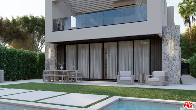 rear view of house with a yard and a patio area