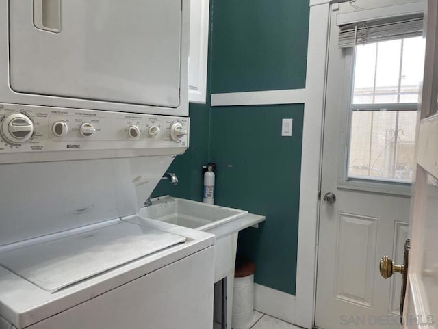 laundry area featuring stacked washer / dryer