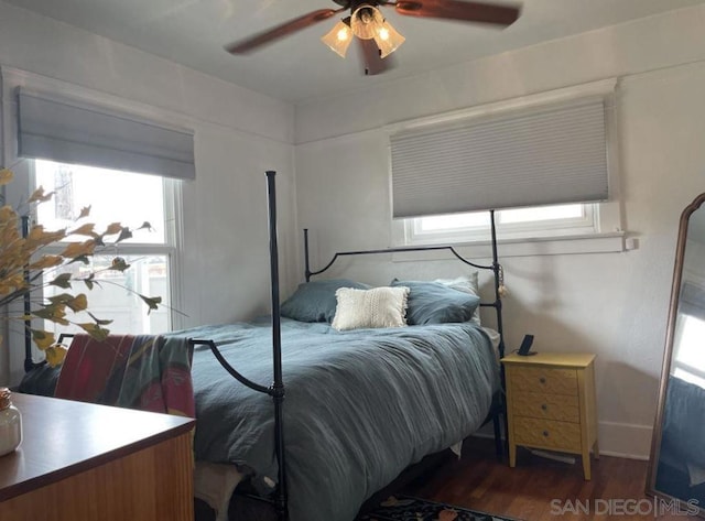 bedroom with dark hardwood / wood-style floors and ceiling fan