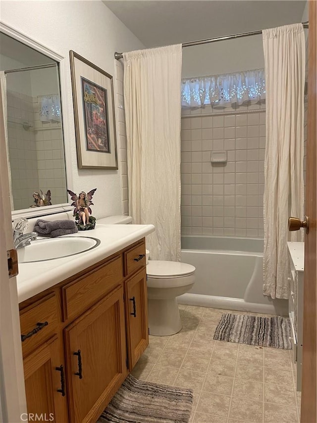 full bathroom featuring tile patterned floors, vanity, toilet, and shower / bath combo with shower curtain