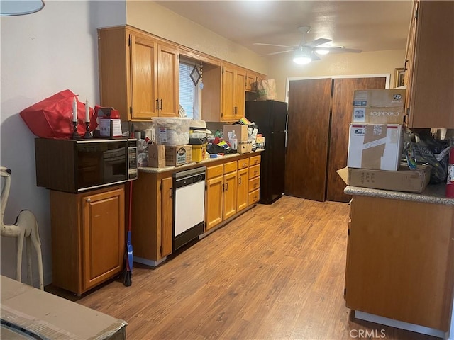 kitchen with dishwasher, black fridge, decorative backsplash, ceiling fan, and light hardwood / wood-style floors