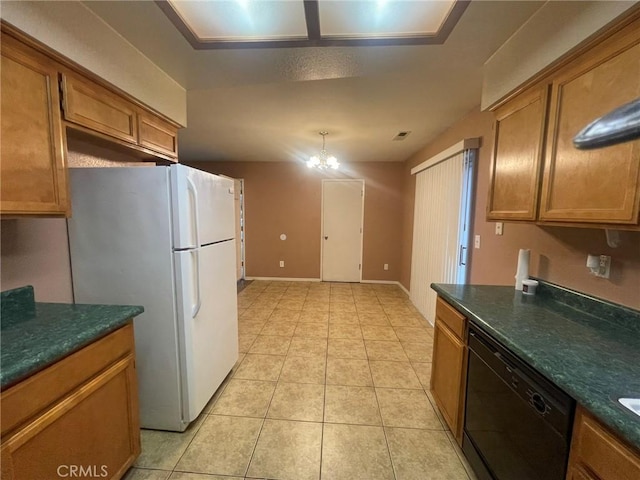 kitchen featuring white fridge, a chandelier, light tile patterned floors, and black dishwasher