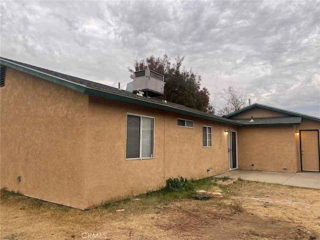 back of house with central AC and a patio