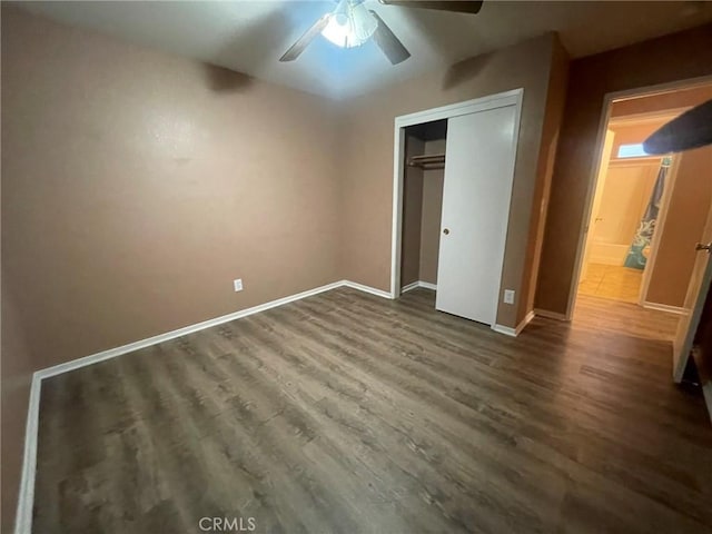 unfurnished bedroom featuring dark hardwood / wood-style flooring, a closet, and ceiling fan