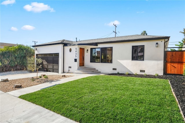 single story home featuring a front yard and a garage