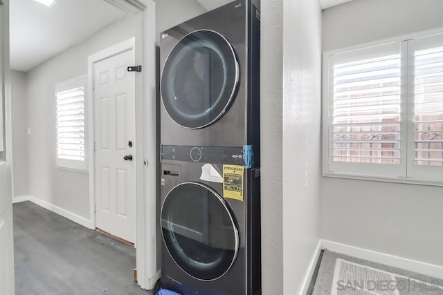 washroom featuring stacked washer / dryer