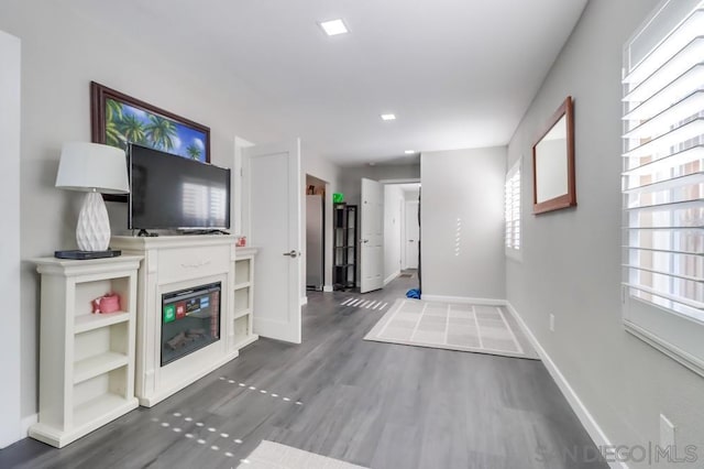 unfurnished living room with dark wood-type flooring